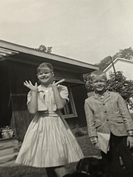 A boy and girl posing for a picture