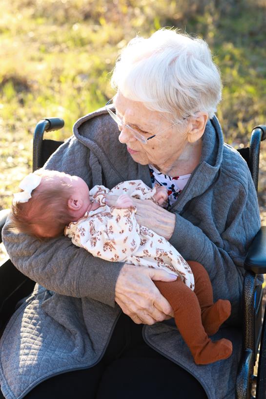 An old woman holding a baby