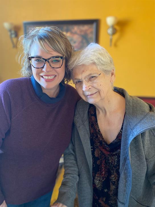 A woman and a woman posing for a picture