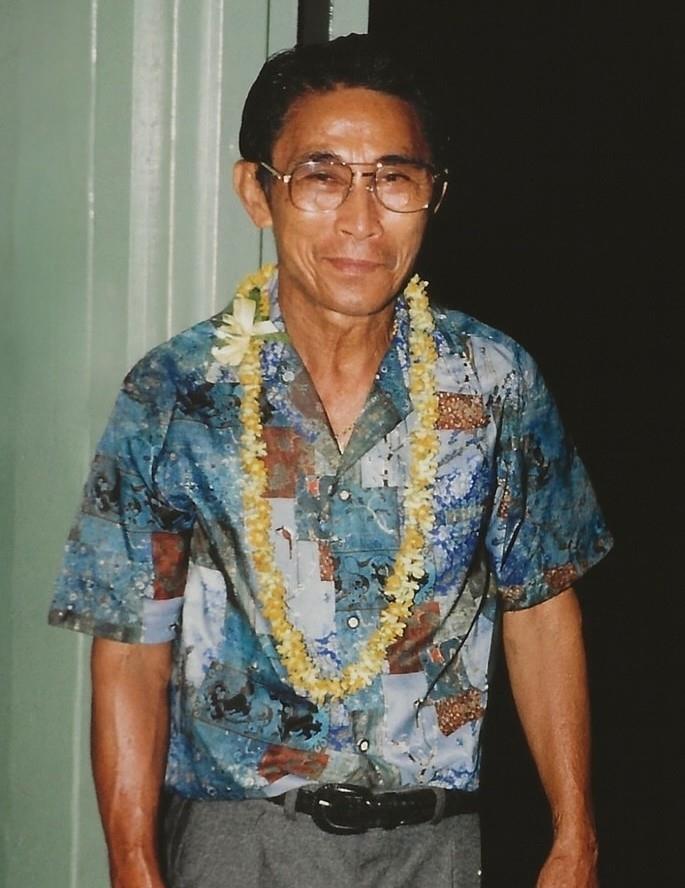 A man wearing a hawaiian shirt and a lei