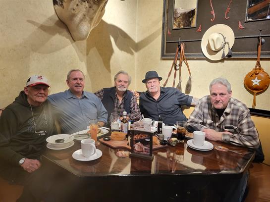 A group of men sitting at a table