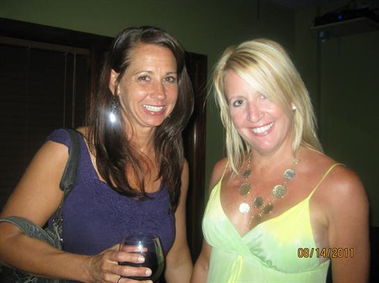 A couple of women smiling at camera