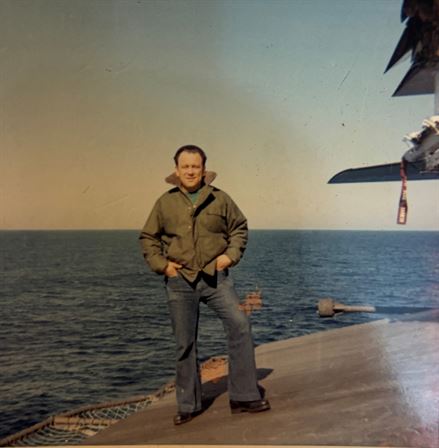 A man standing on a deck of a ship