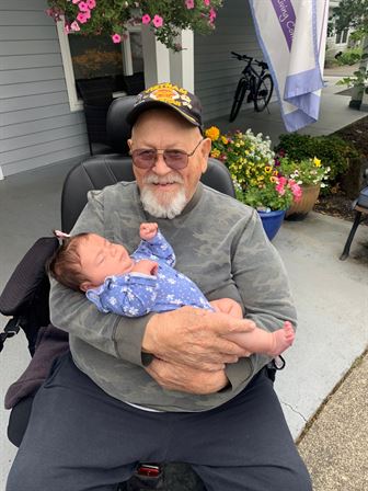 An old man holding a baby