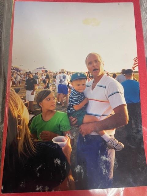 A man holding a baby and a woman holding a child