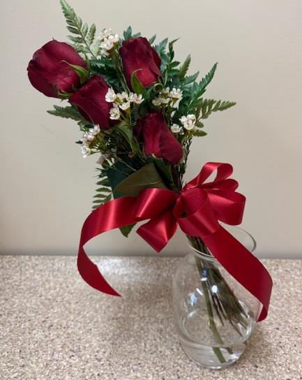 A bouquet of red roses in a glass vase