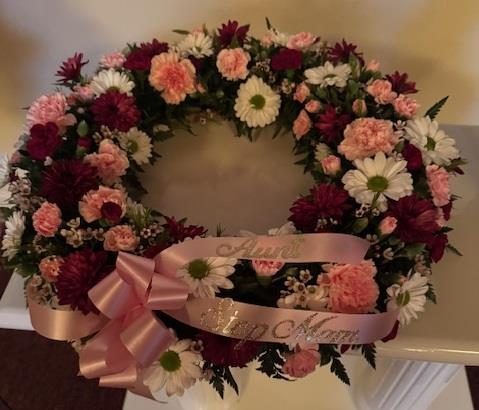 A wreath of flowers with a ribbon