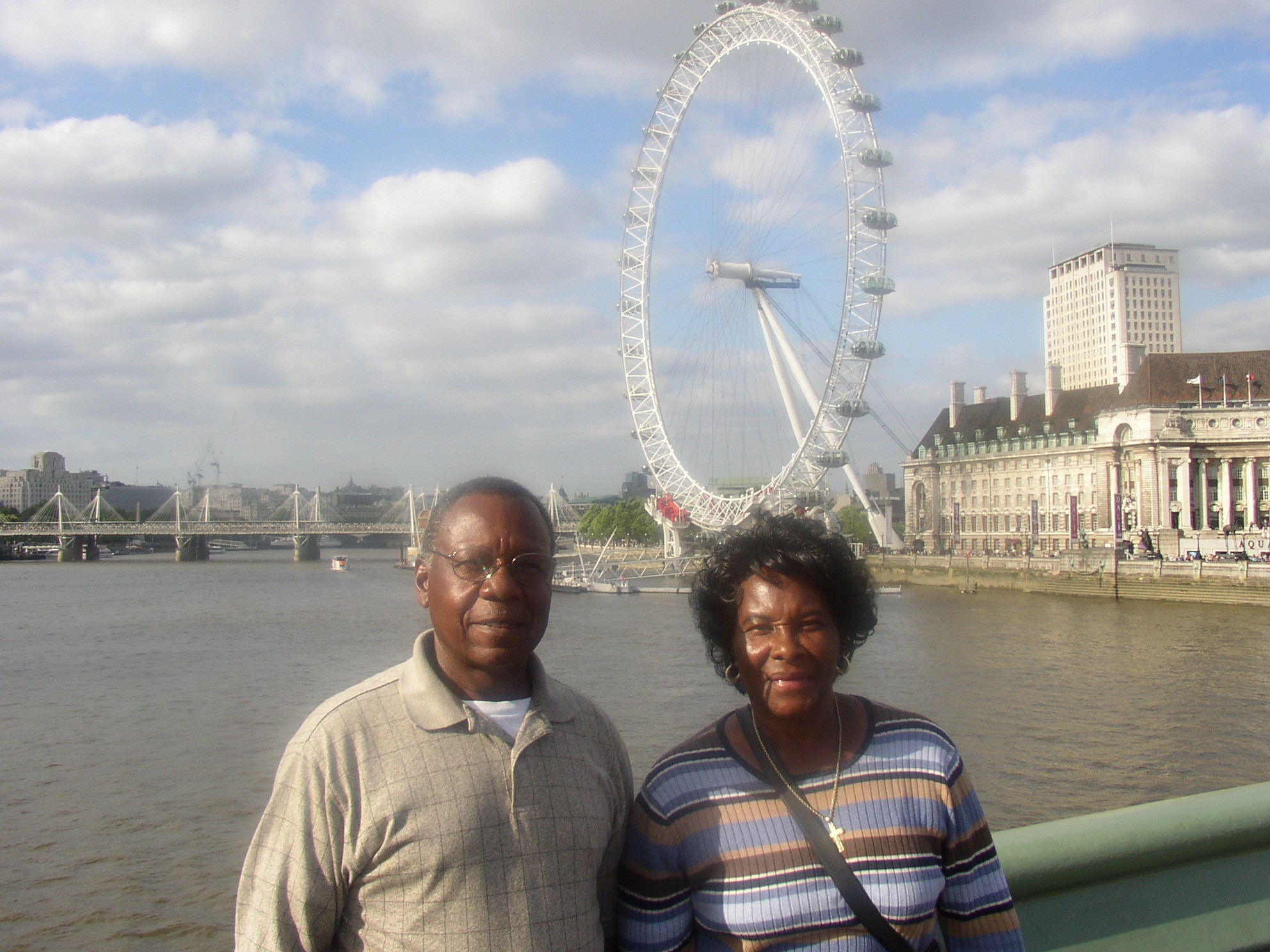 A man and woman standing in front of a ferris wheel