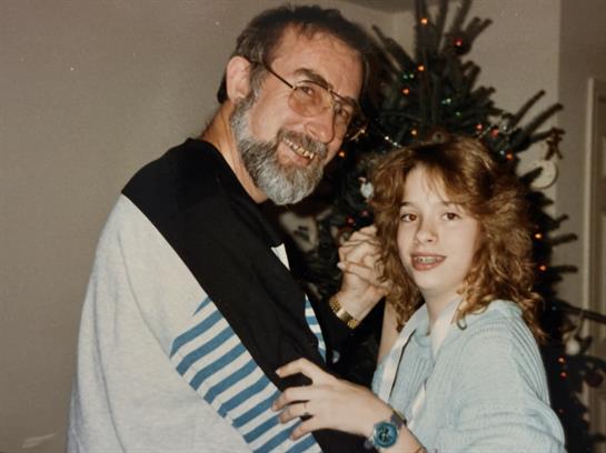 A man and a girl posing for a picture