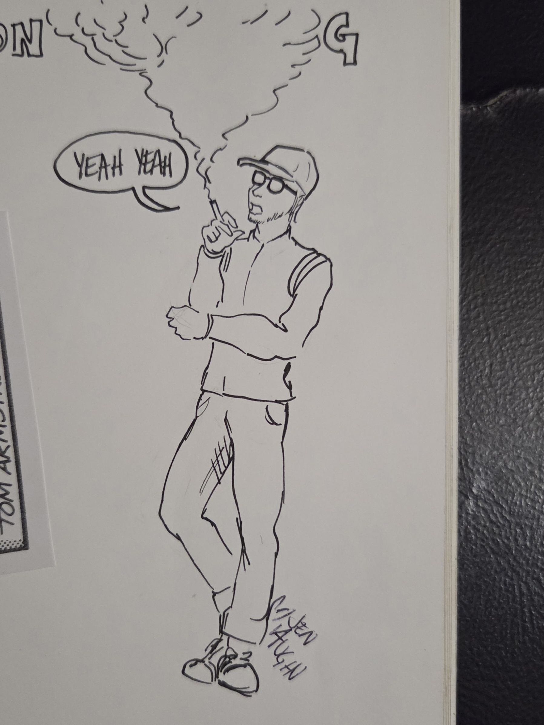 A person stands with a cigarette, wearing glasses and a cap, showing excitement while smoking.