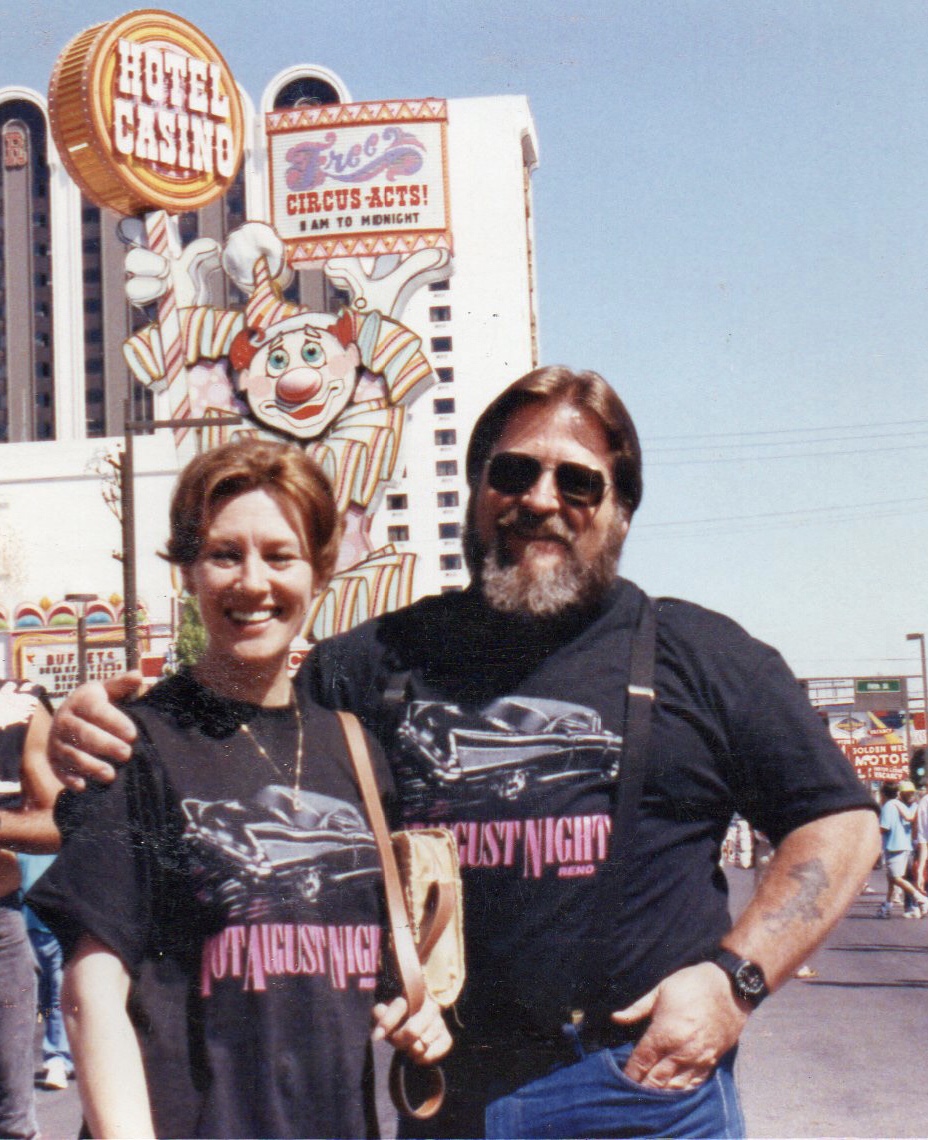 A couple in matching shirts poses outside Circus Circus, enjoying the moment together.