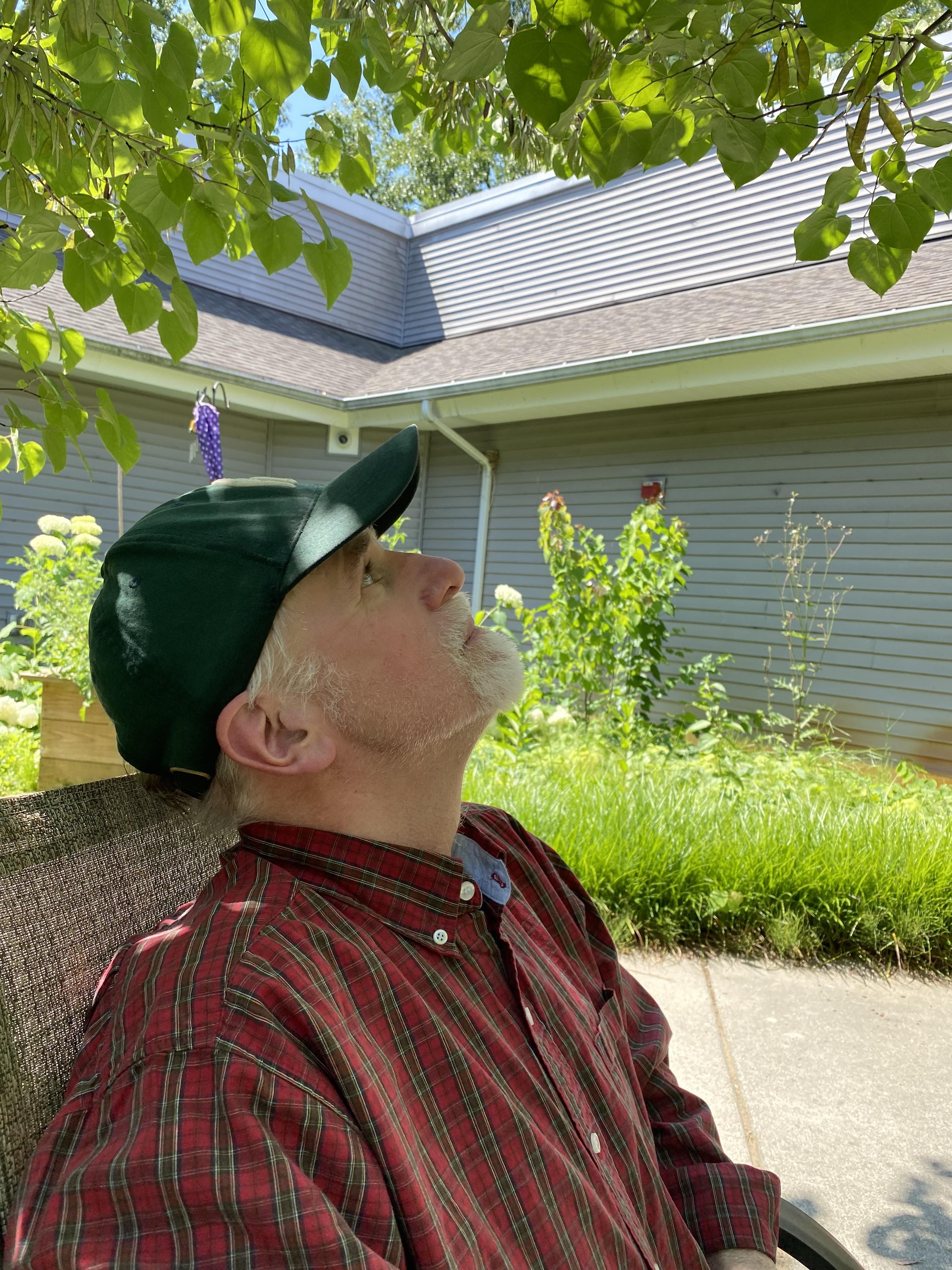 A man sitting on a bench outside