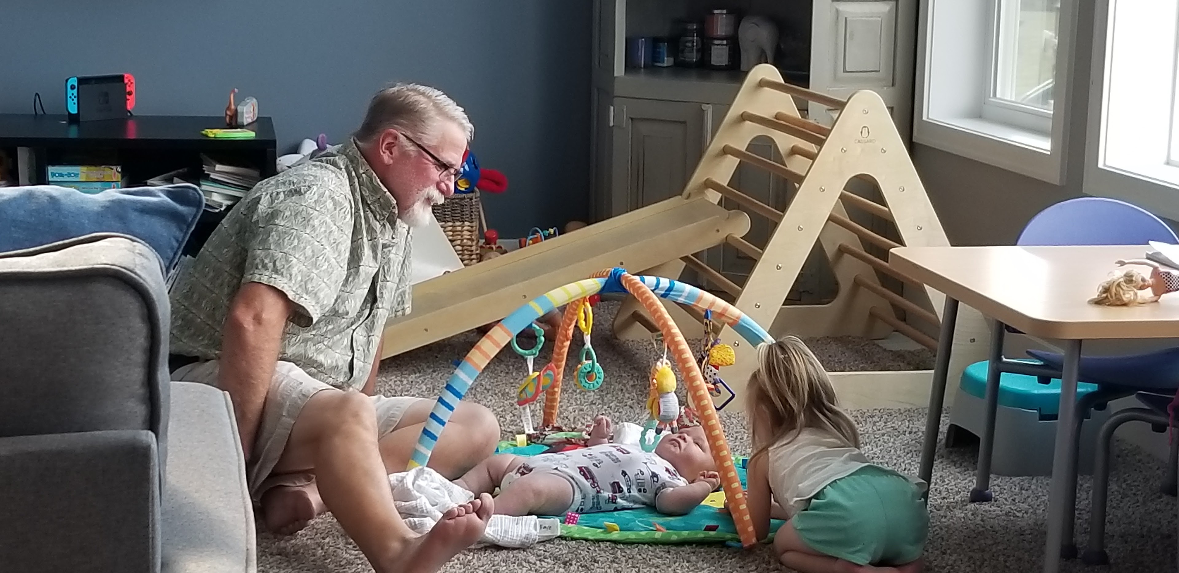A man and a baby playing with toys