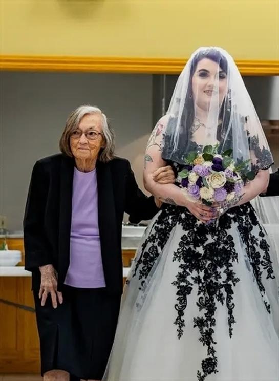 A woman in a wedding dress with a bouquet of flowers