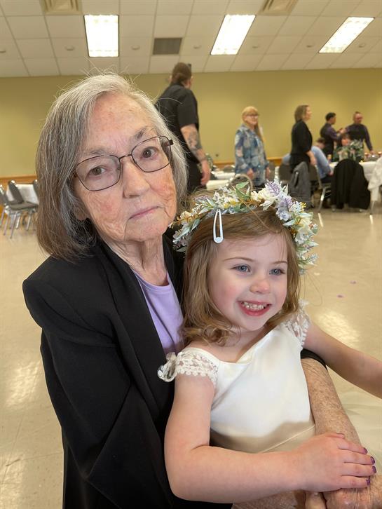 An older woman and a young girl posing for a picture