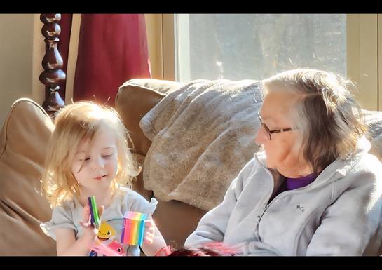 A woman and a child sitting on a couch