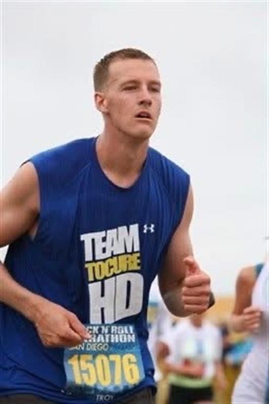 A man running in a blue shirt