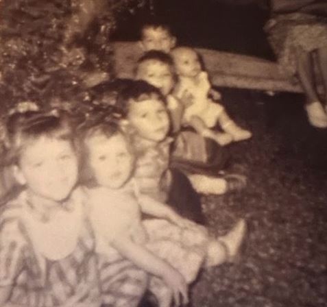 A group of children sitting on the ground