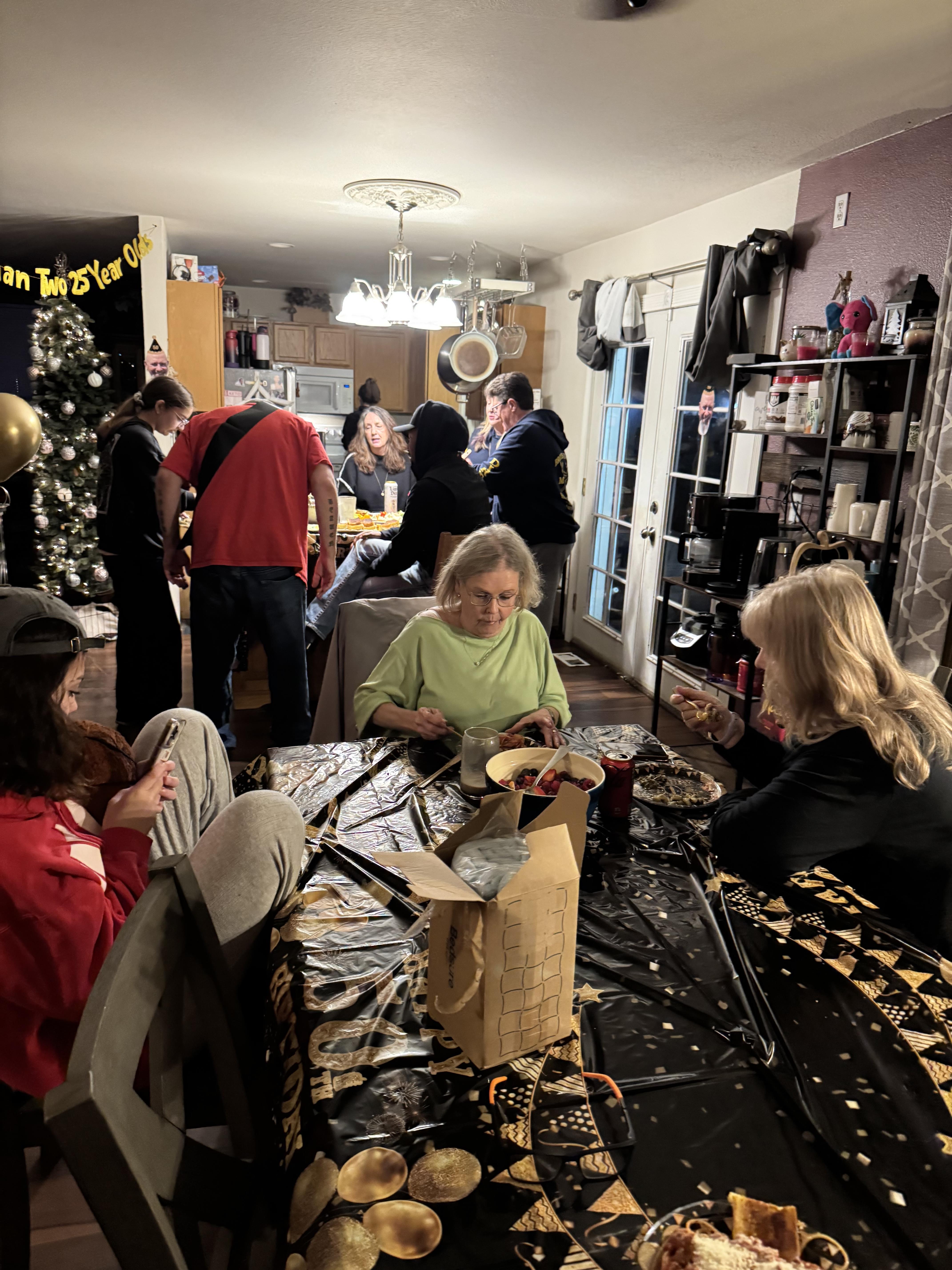 People are busy creating decorations and snacks in a home during a holiday celebration.