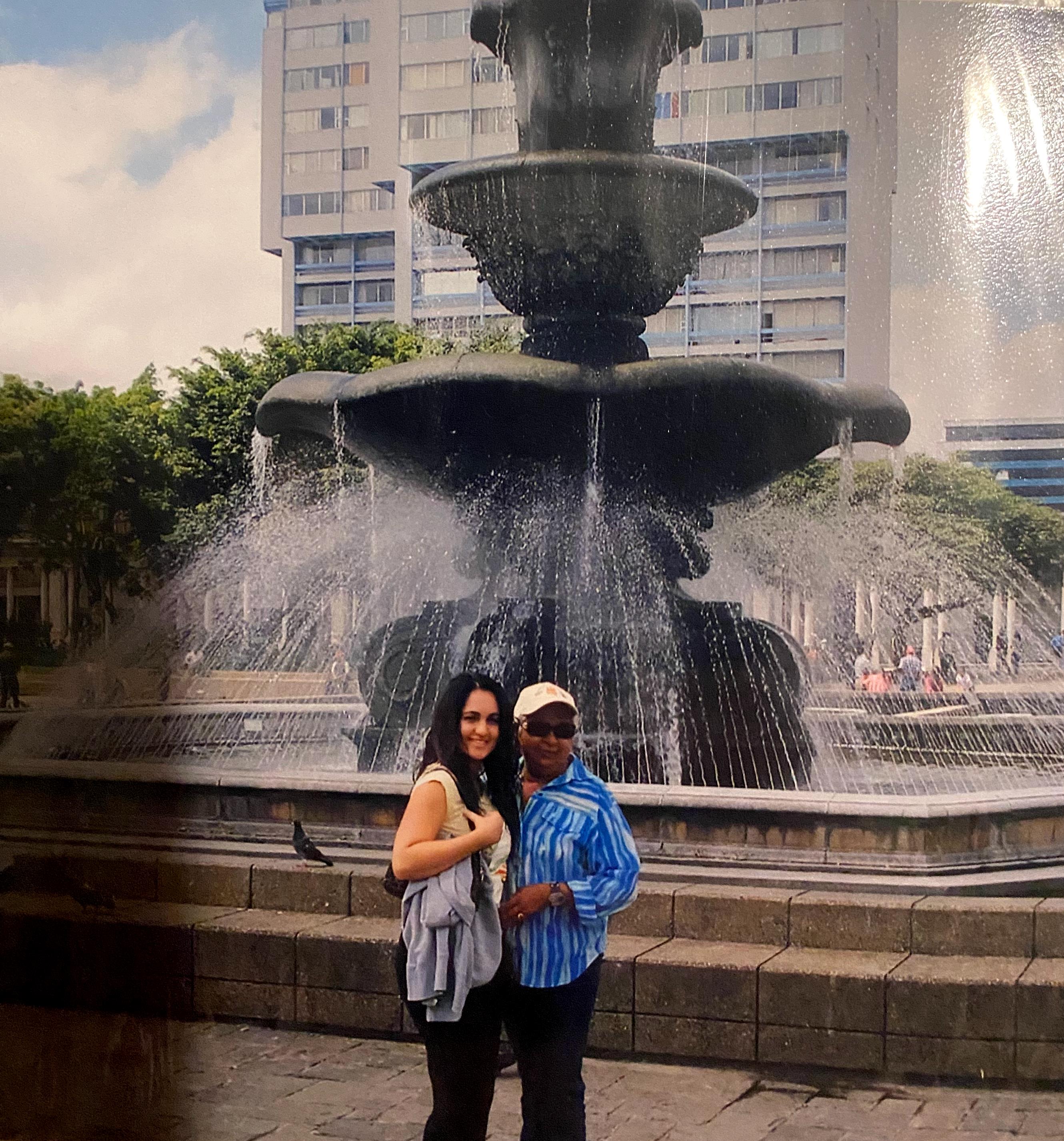 Two women standing in front of a fountain