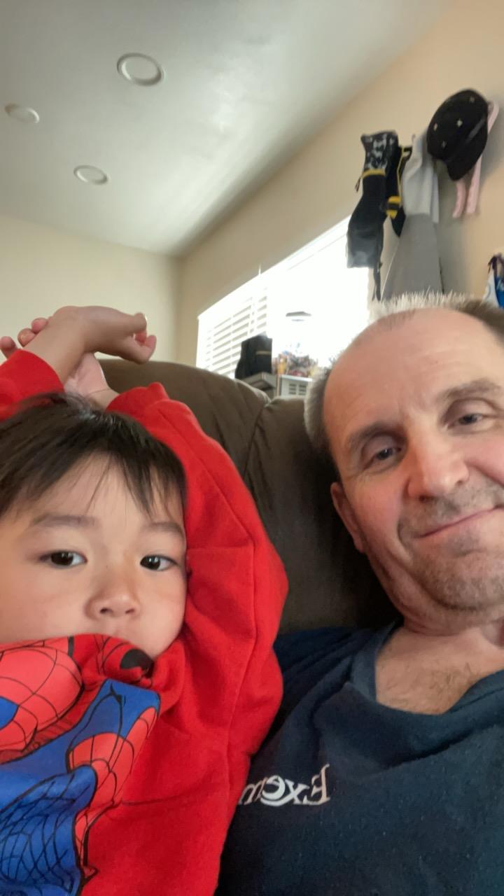 A man and a child posing for a selfie