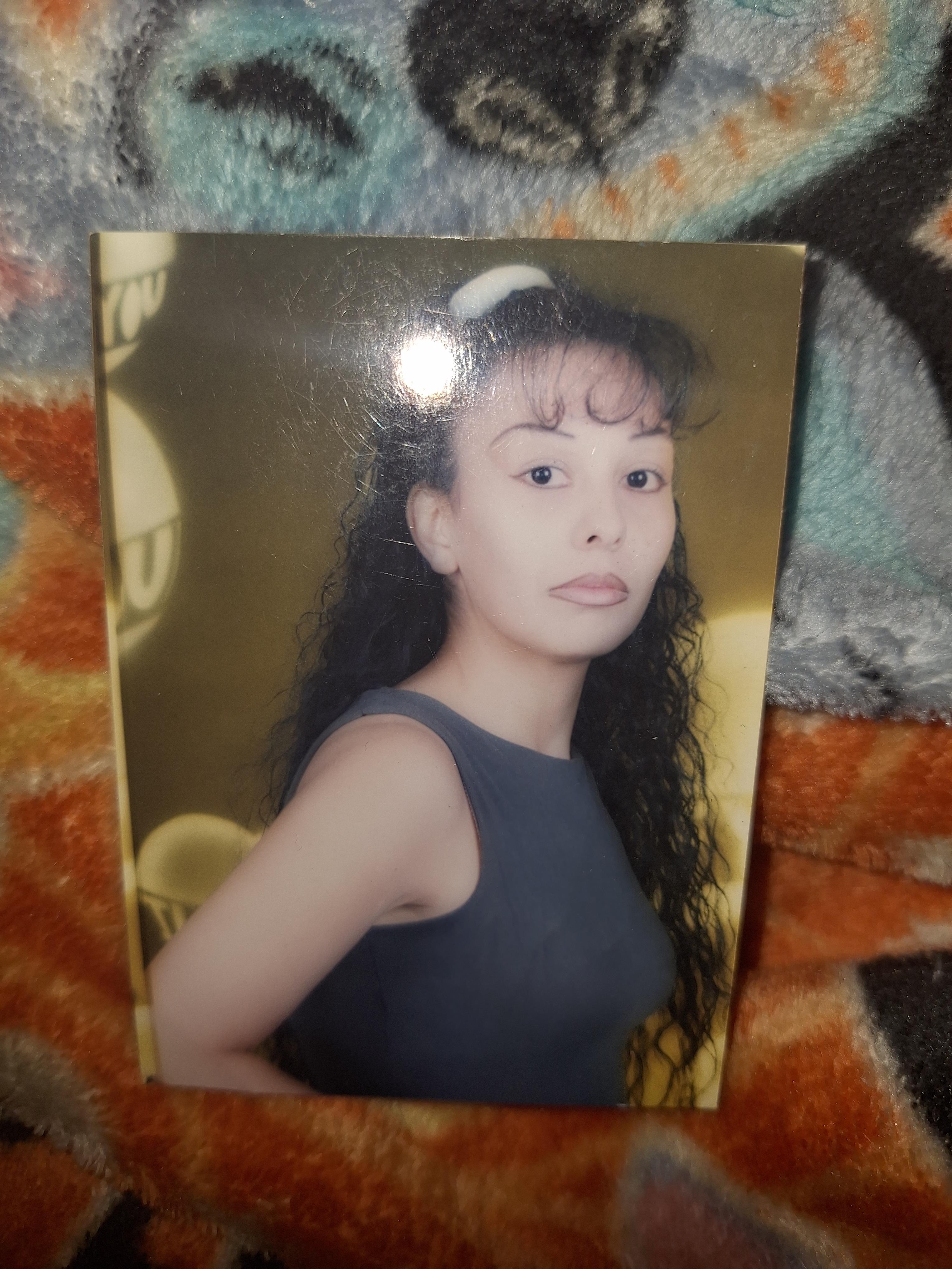 A young woman stands confidently while posing for a picture.