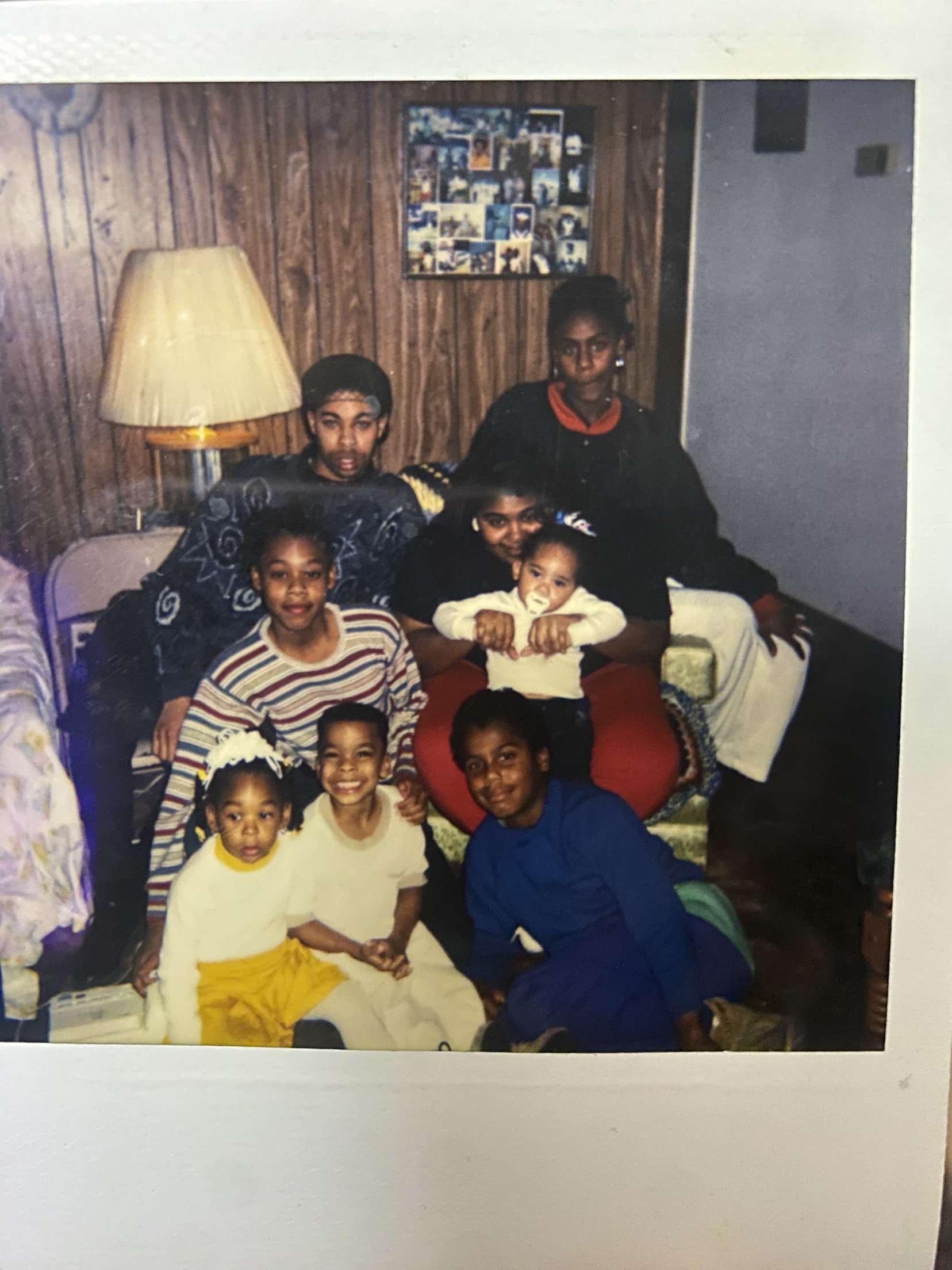 A group of family members is seated together in a living room.