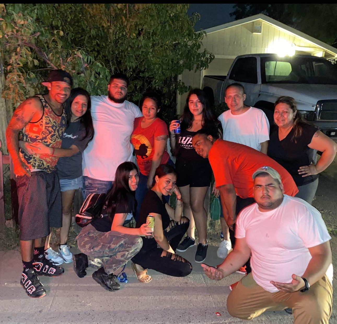 Friends enjoy their time together outside at night taking photos and sharing laughs.