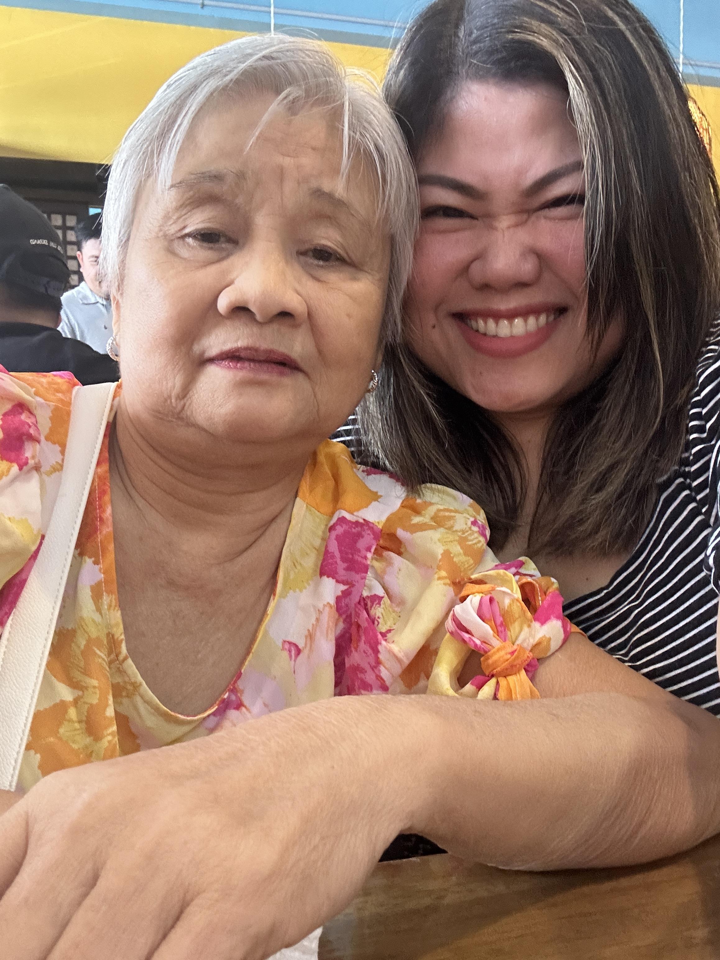 Two women enjoy lunch at a restaurant. One is older and the other is younger.