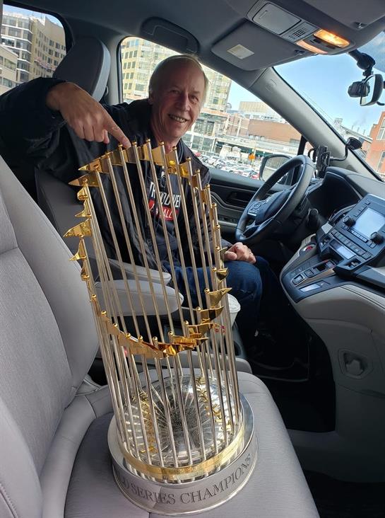 A man pointing at a trophy