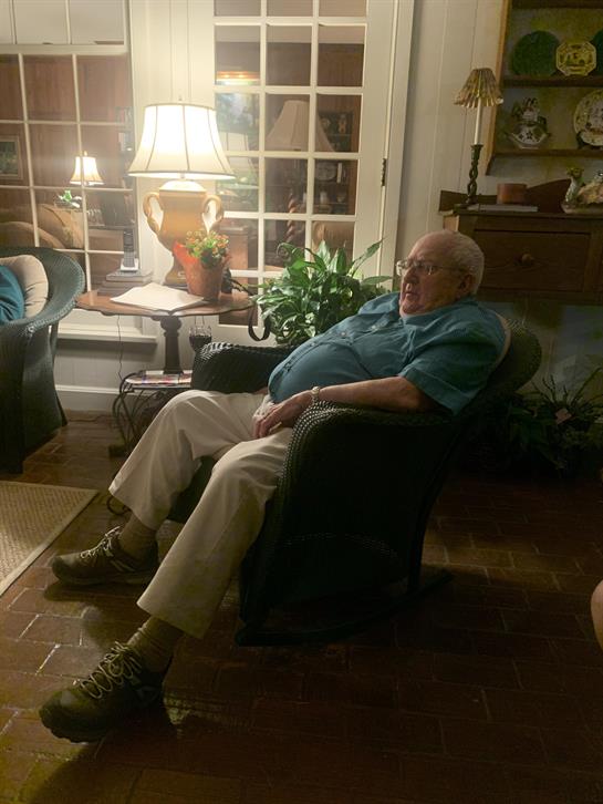 An old man sitting in a chair