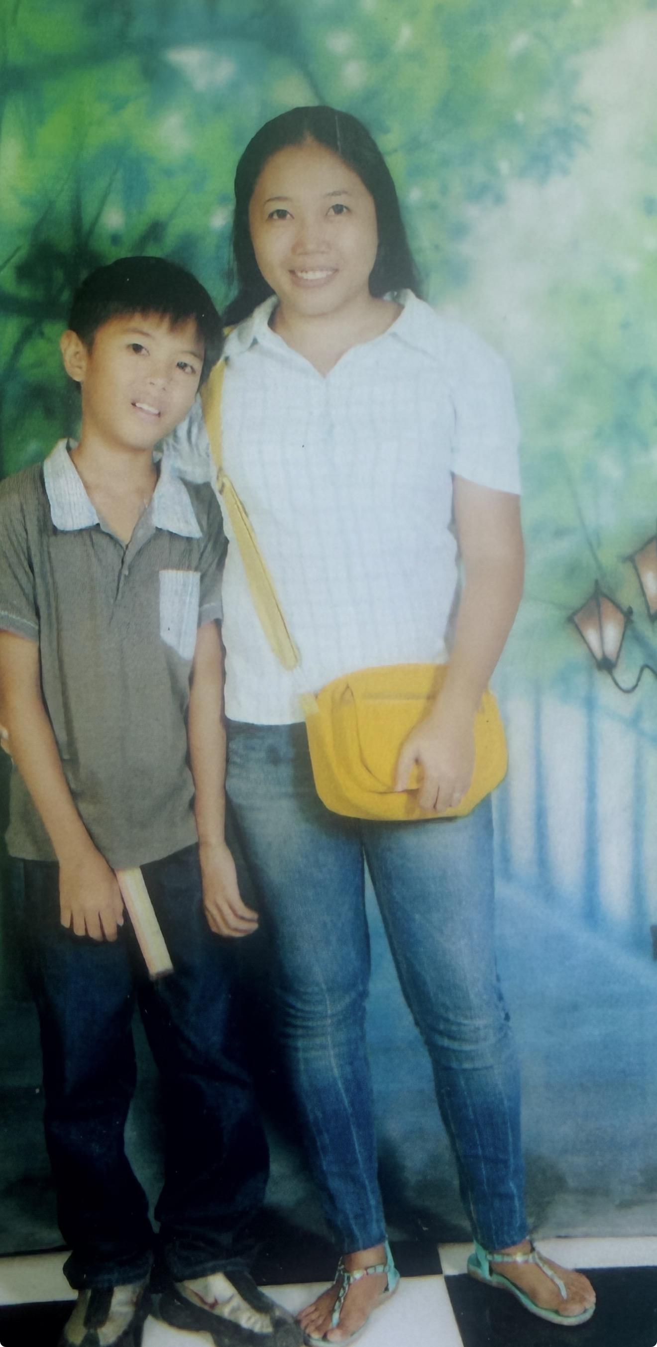 A man and boy posing for a picture