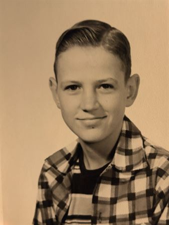 A boy smiling for a picture