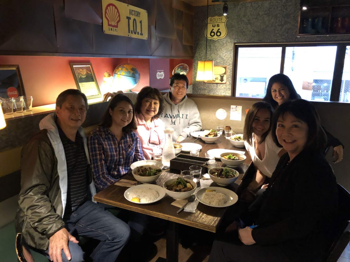 A group of people sitting around a table with food