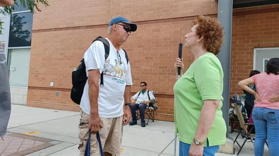 A man and woman standing outside