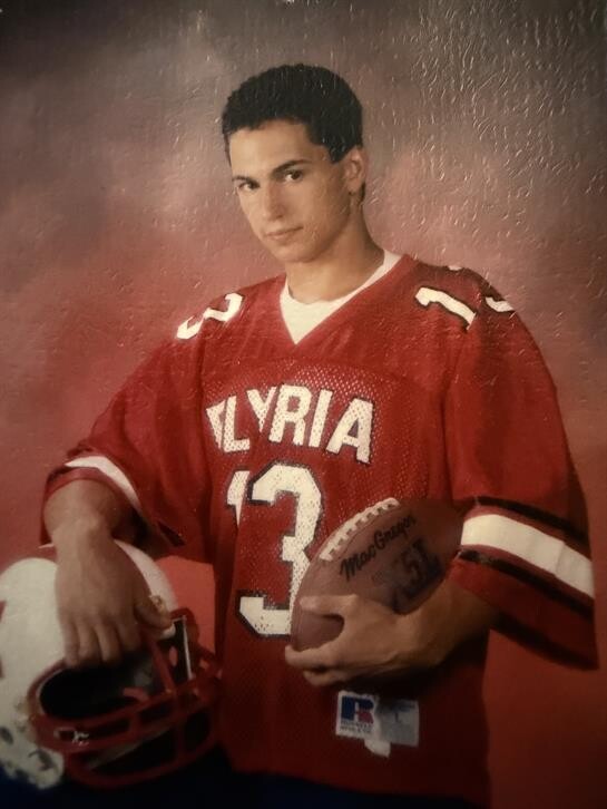 A man holding football and a football