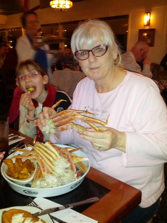 A woman and child eating crab legs