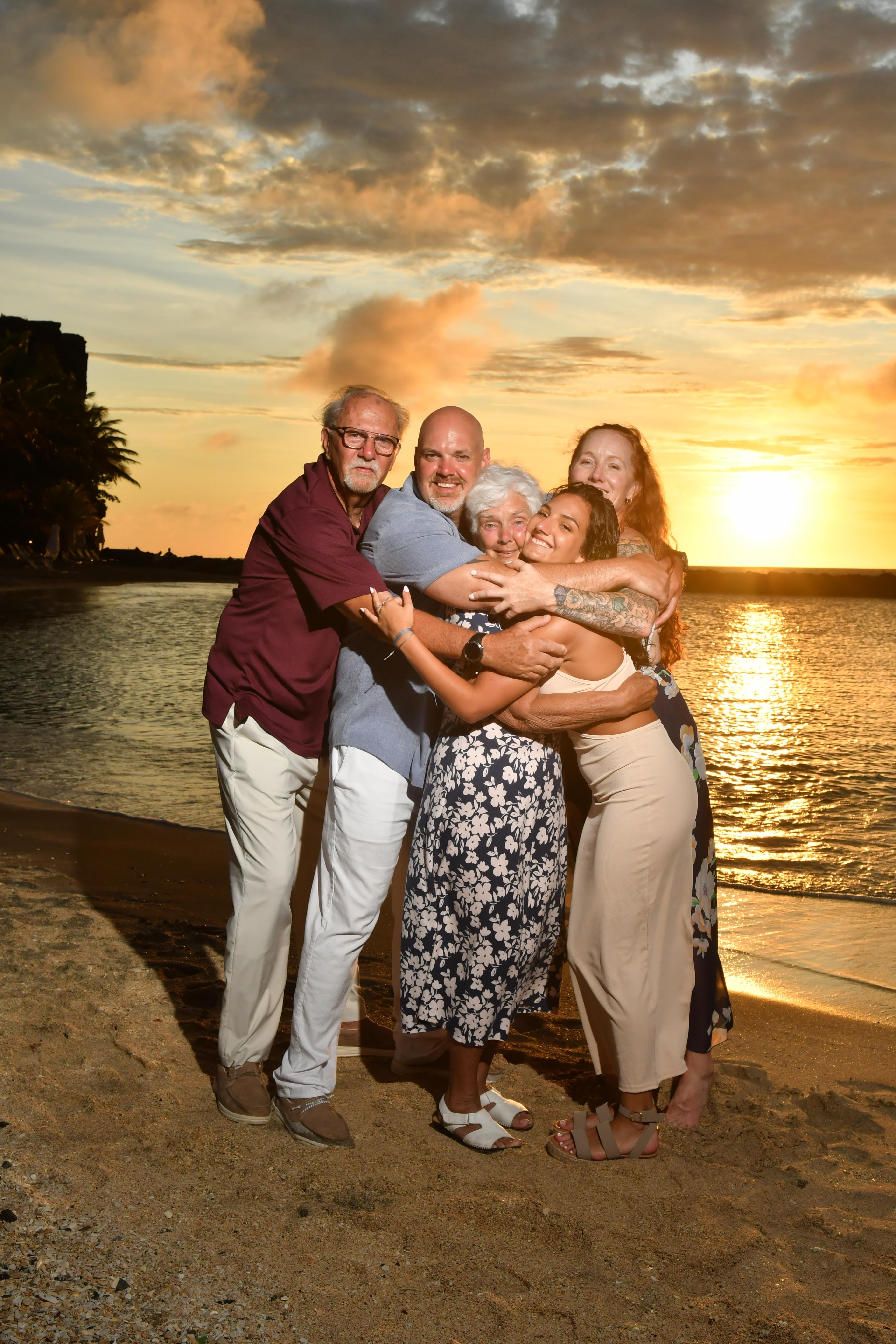 A group of people hugging on a beach