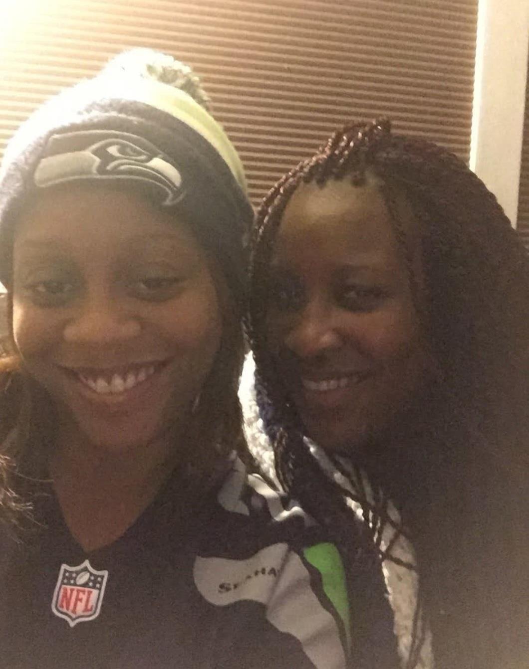 Two friends enjoy each other's company and share a moment while smiling at home in the evening.