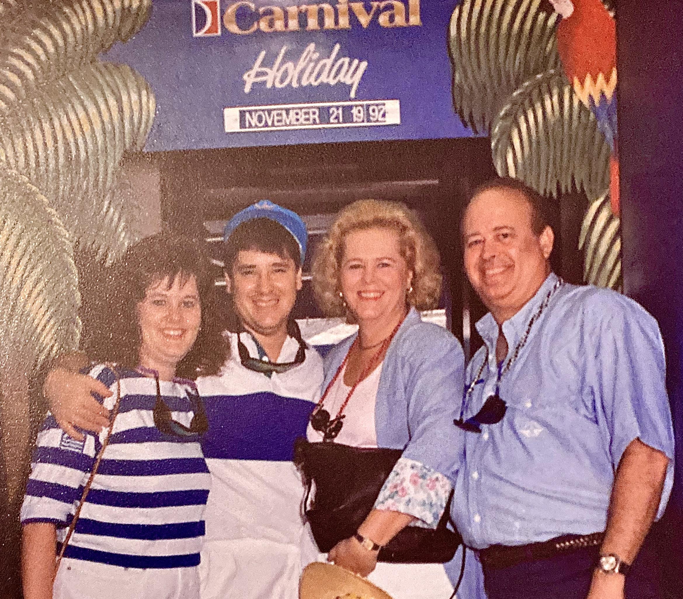 A group of people standing in front of a sign
