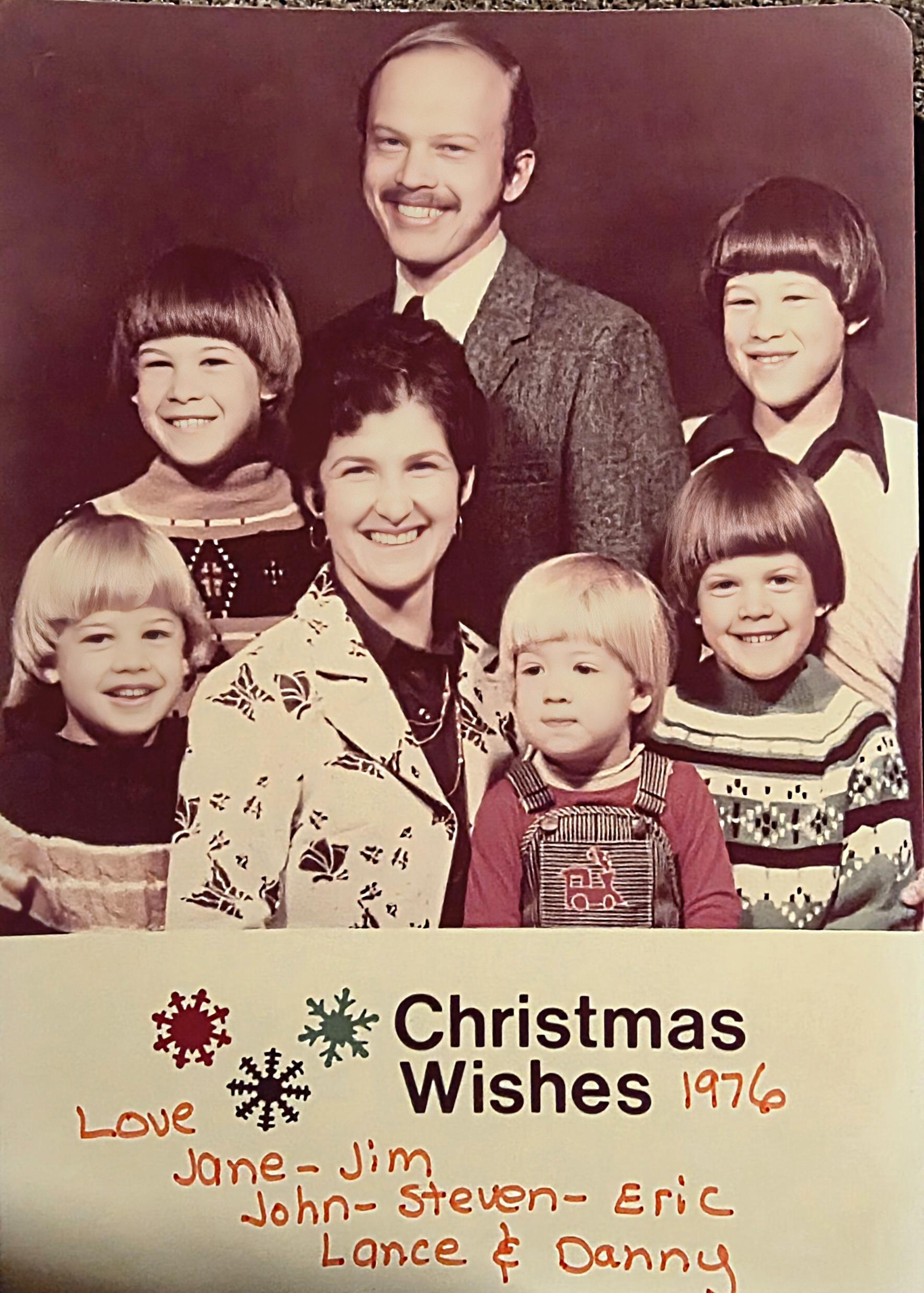A family gathers for a Christmas portrait in 1976, showing happy faces and festive clothing.