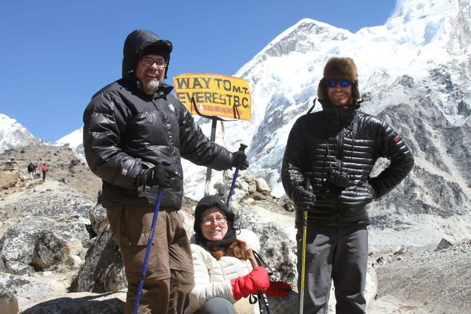 A group of people standing in front of a snowy mountain