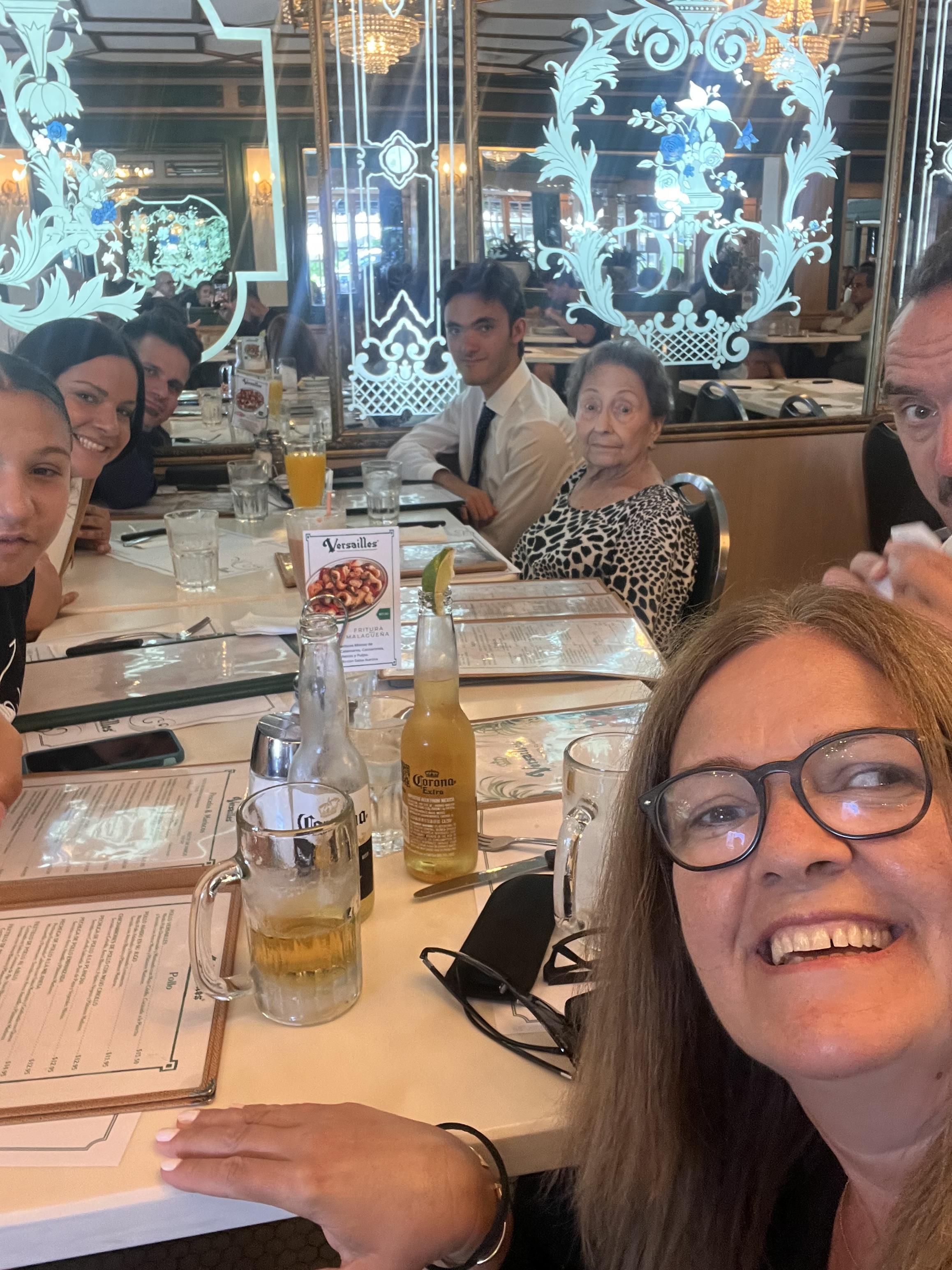 Friends gather at a restaurant for dinner, sharing stories and enjoying drinks together.
