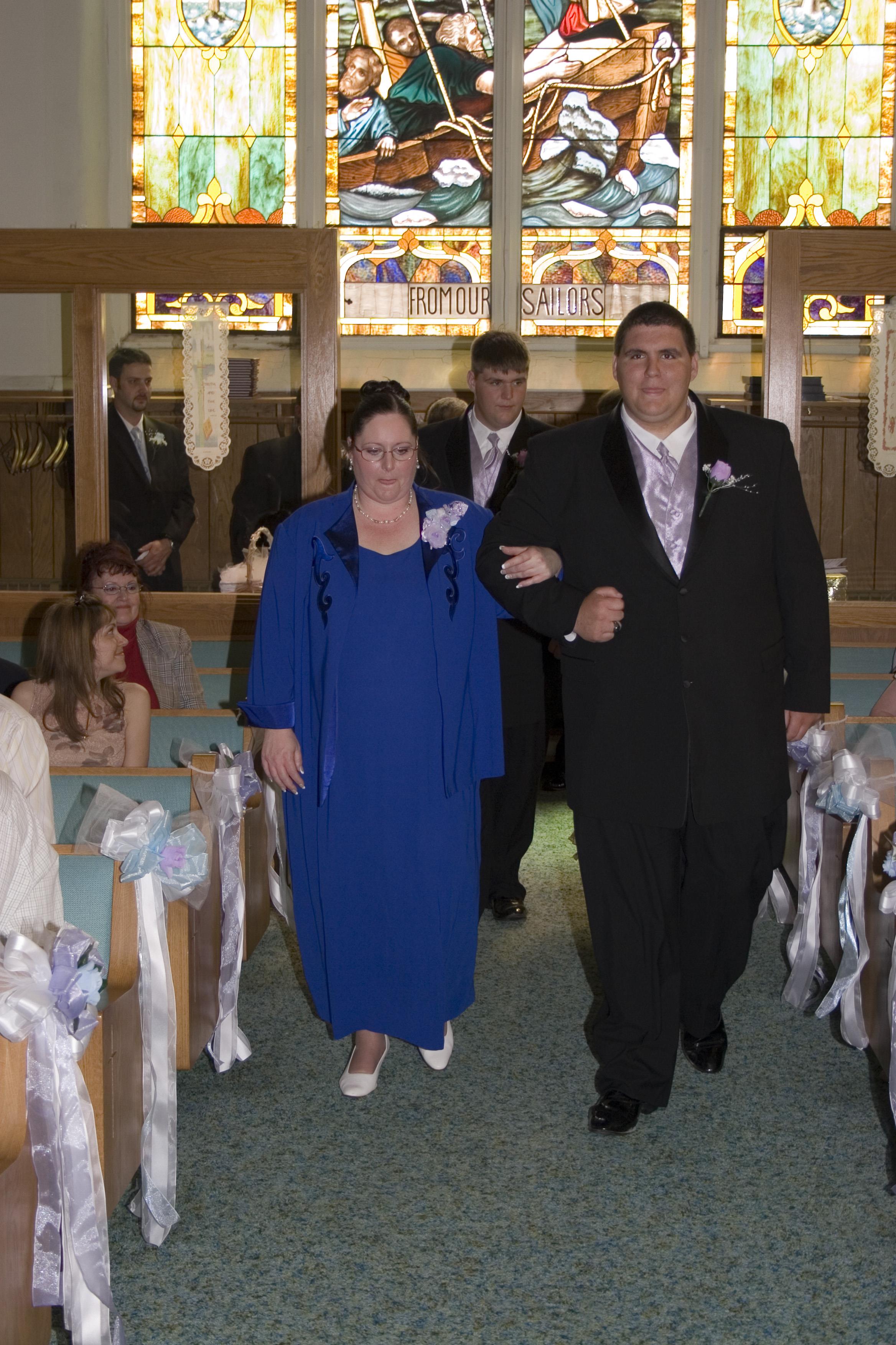 A man and woman walking down the aisle