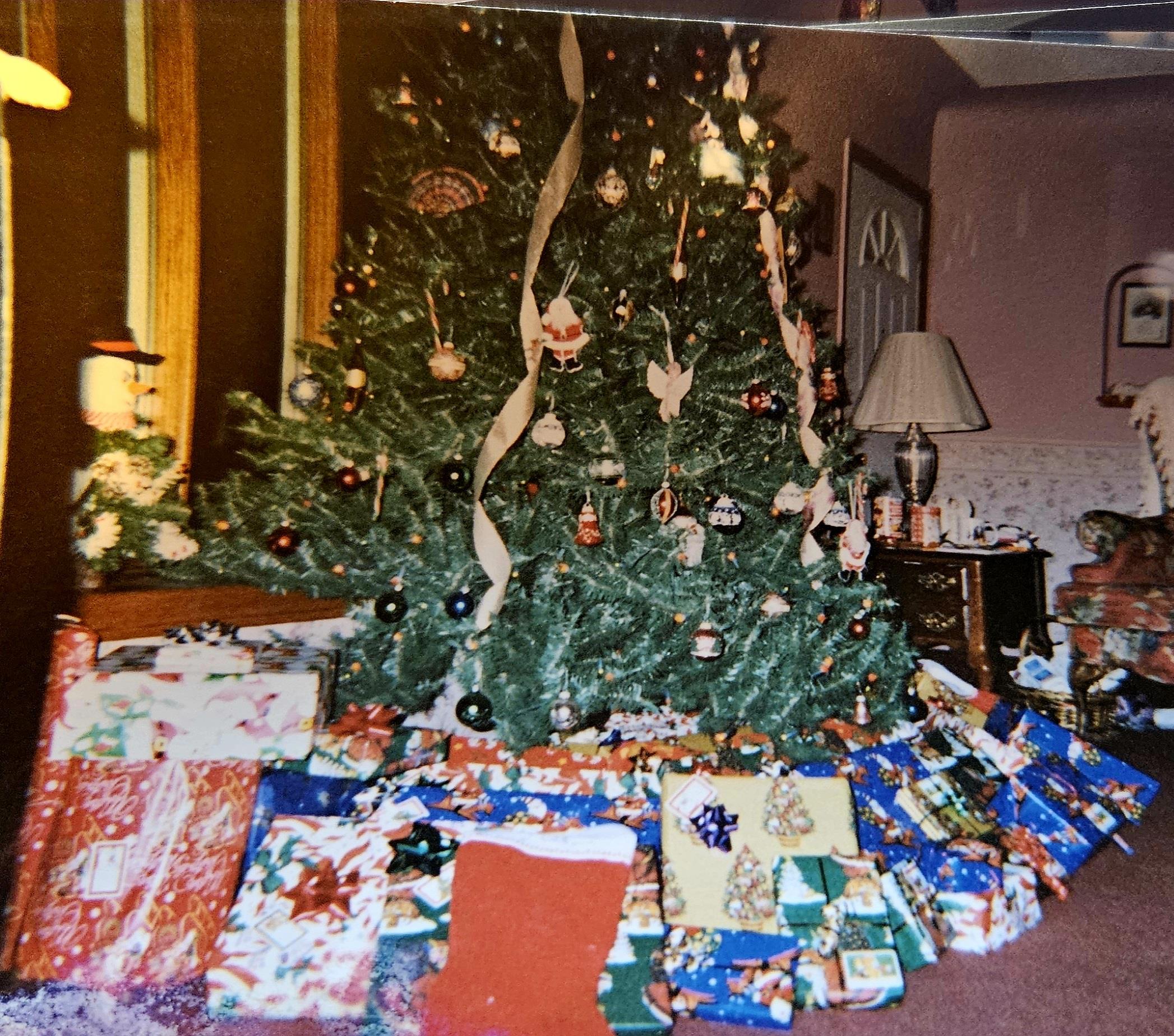 A christmas tree with presents around it