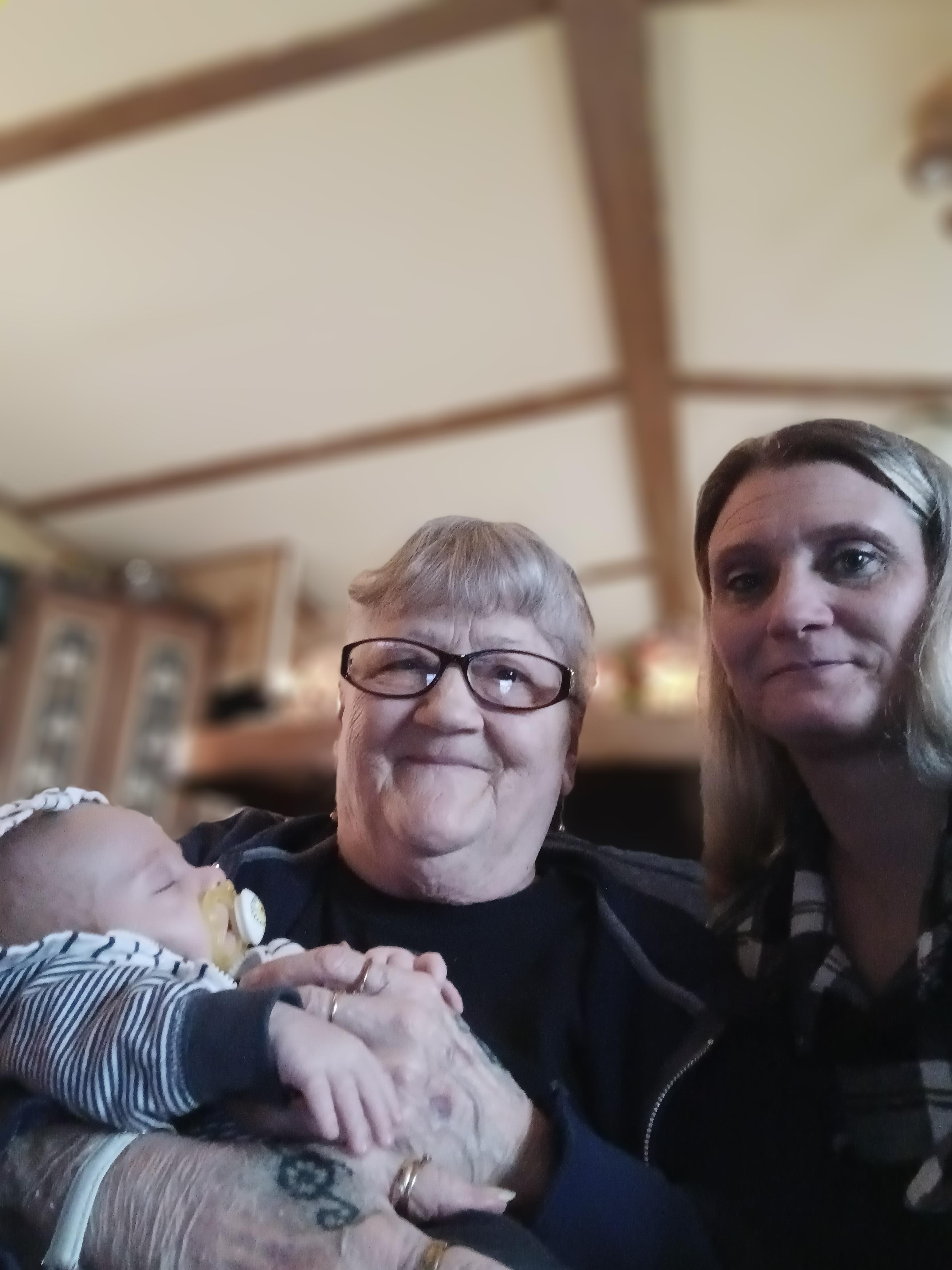 A group of women holding a baby