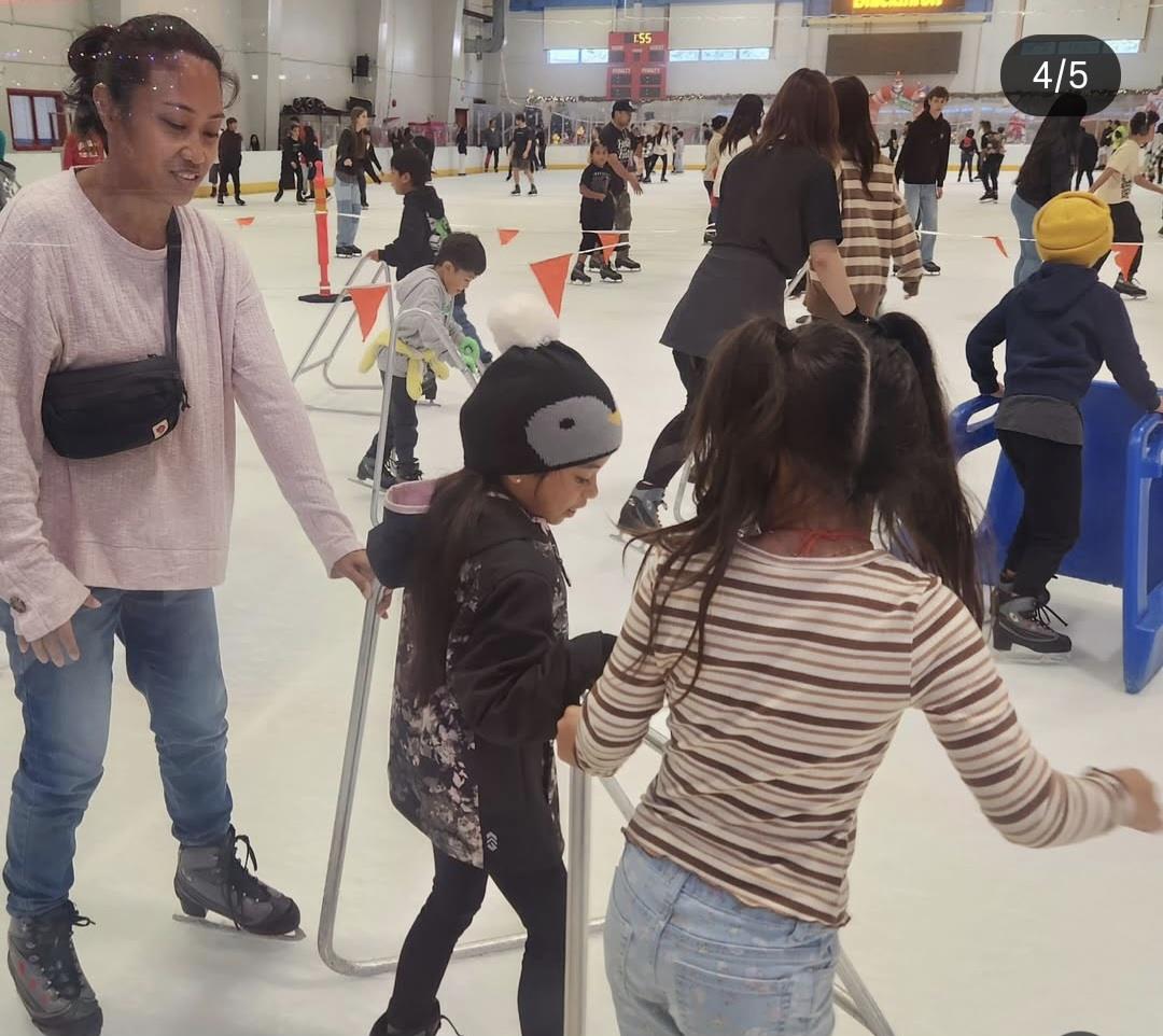 Kids practice ice skating while parents support them in a busy rink during a fun day.