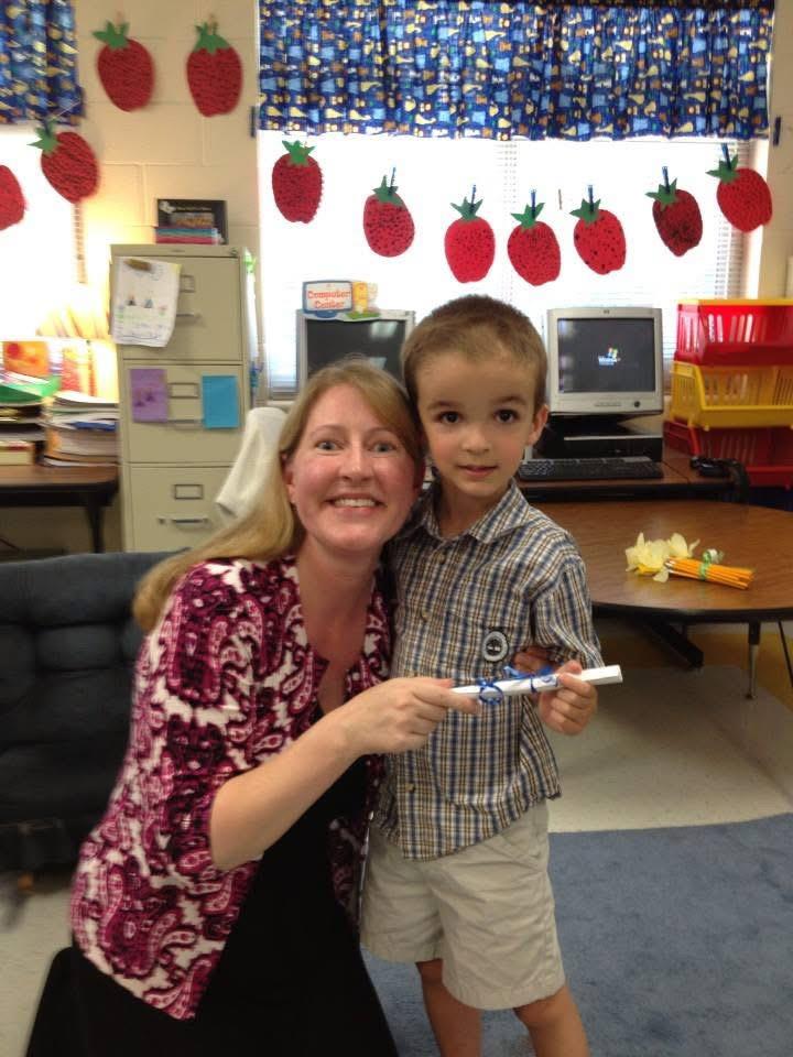 A woman and a boy posing for a picture