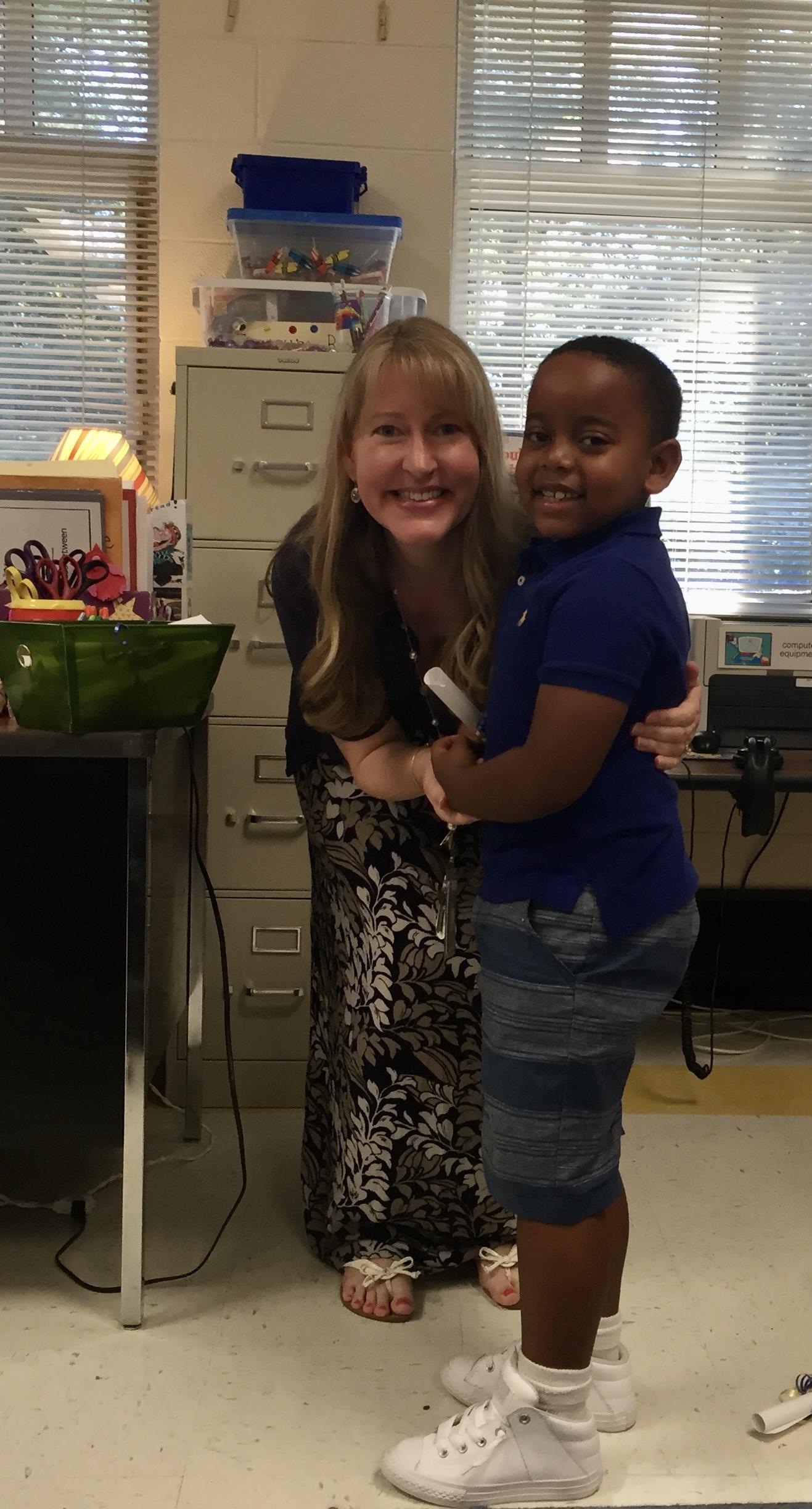 A woman hugging a boy