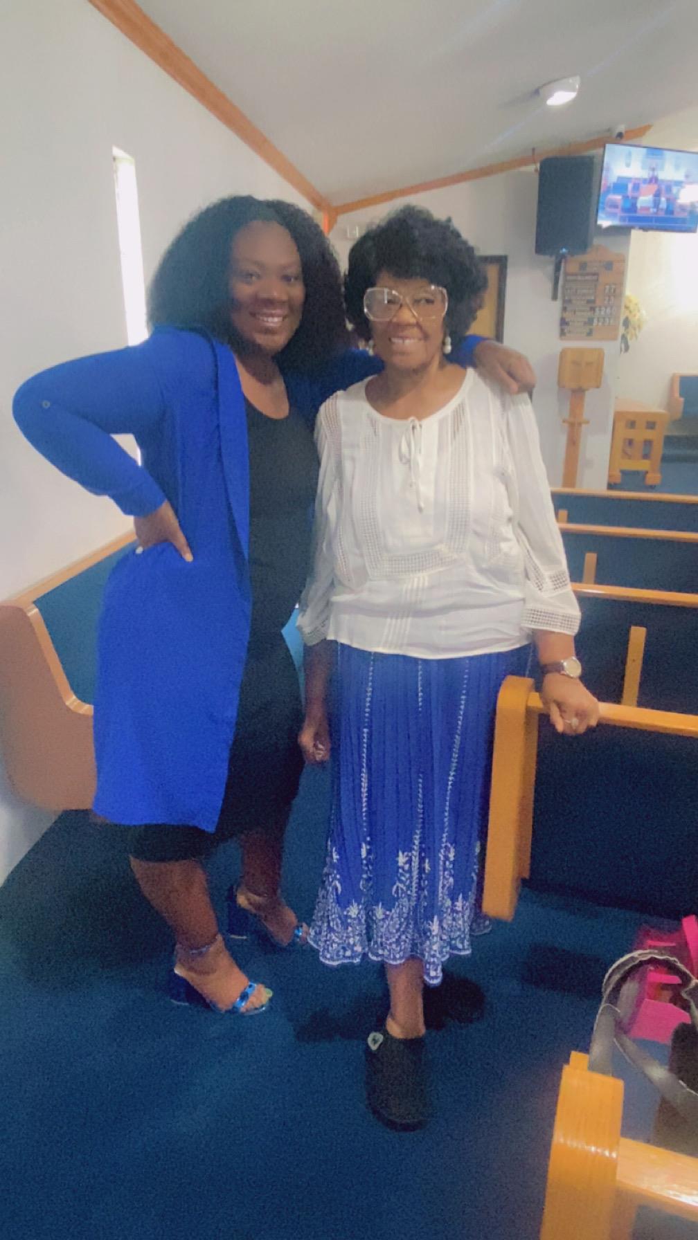 Two people pose happily inside a church.